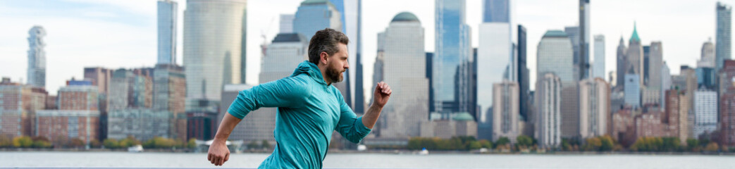 Man runner in sport outfit run in NYC. Motion, healthy run. Mature jogger run near Manhattan...