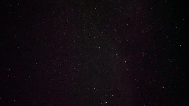 Starry sky. In the center is the constellation Delphinus. At the bottom right you can see one of the brightest stars - Altair. Satellites move across the night sky.
