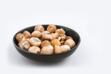 mushrooms champignon in  bowl on white background
