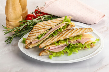 Homemade club sandwich with ham and cheese