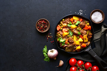 Meat stew with vegetables. Top view with copy space.