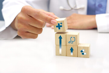 Hand holding a wooden block cube with healthcare medical icon symbol. Medical and health concept.