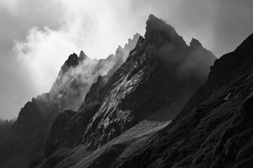 A monochromatic massif looms high above the fog-covered landscape, its summit hidden in the clouds, creating a serene and majestic outdoor scene - obrazy, fototapety, plakaty