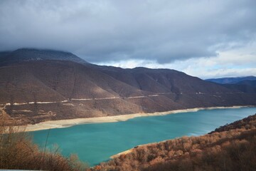 Water reservoirs and mountains in winter. Warm southern winter. Mountains without snow