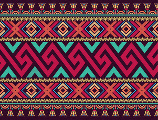 Colorful seamless pattern design in vintage style with Greek key, geometric, and Egyptian lotus motifs on a dark purple background. Use for fabric, textiles, clothes, skirts, wrapping, and wallpaper.