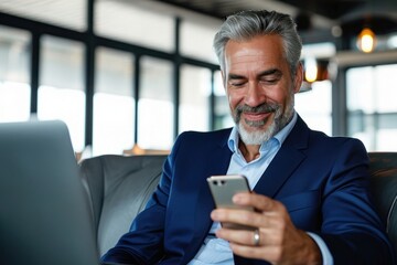 Naklejka na ściany i meble Happy middle aged business man ceo wearing blue suit sitting in office using cell phone. Older businessman professional executive holding mobile satisfied with enterprise solution, Generative AI 