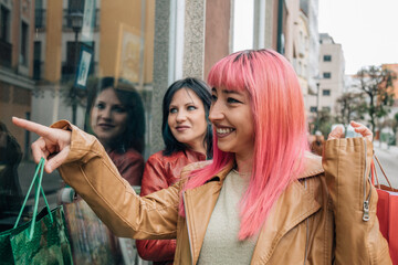 Fototapeta premium female friends shopping with bags on the street