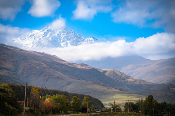 Snow-capped peak in the mountains with surrounding landscape