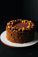 Tasty chocolate cake with almond, on old wooden table