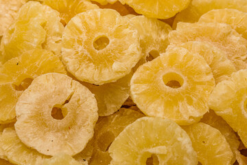 Dried preserved pineapple fruits. Background of the candied fruit slices