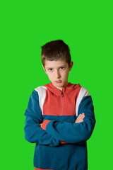boy in a casual style feeling annoyed and showing sad expression on green background.