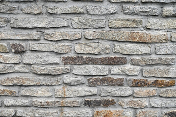 Gray grunge banner. Abstract stone background. The texture of the stone wall. Close-up. Light gray rock backdrop.