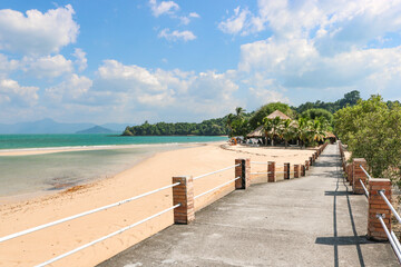 Fototapeta premium A bridge along the coast leading to a resort on a tropical island. Vacation, travel, relaxation concept.