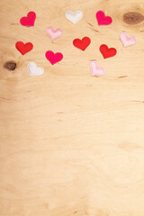 A lot of small hearts on wooden background with copy space. Greeting card with Romantic scene on...