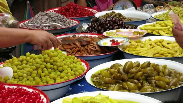 Selling variation of pickled fruits, Thailand