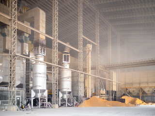 Rice milling factory interior, paddy drying machine and loading area. Post-harvest processing of...