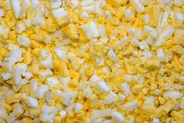 cut the chicken egg into small cubes in large quantities. salad preparation