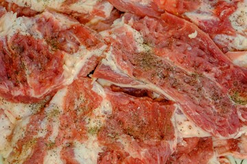 topping pork slices with fine pepper. Cut the pork into thin sheets for grilling.