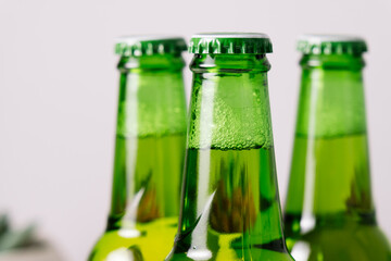 A green bottle of beer with the background out of focus.