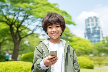 Teenage student holding smartphone after school