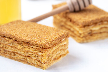 piece of homemade honey cake on white background.