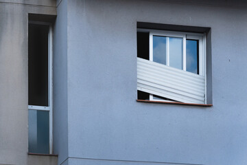 Building window with broken shutter