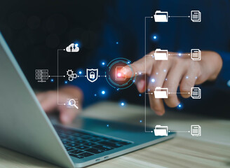 Business people use computers to upload documents from folders to manage online document databases and organize file space on a software system. To disseminate information in various agency offices