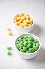 Wasabi and cheese peanuts in bowls