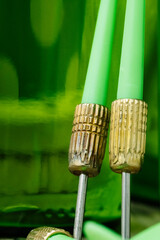 Green darts on a target with beer bottles in the background