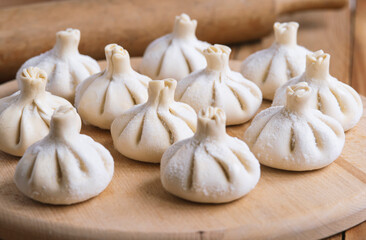 Georgian homemade food called khinkali. Georgian cuisine. On the old wooden background.