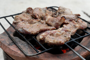 Three pieces of grilled pork on a rubber grill. Place on the charcoal stove.