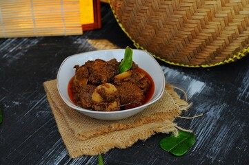 Rendang Jengkol, dogfruit simmered in spices and coconut milk. Indonesian traditional food, with a...