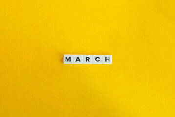 March Word on Block Letter Tiles on Yellow Background. Minimalist Aesthetics.