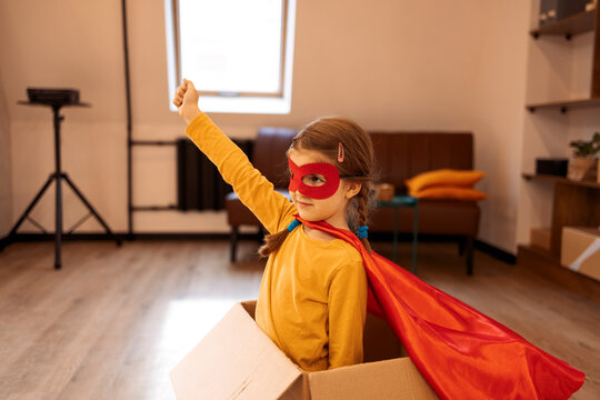 Superhero child. Super hero kid, playing at home in box.