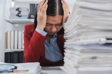 stressed individual with glasses, wearing a red blazer, holding their head in one hand and a pen in...