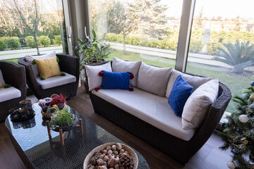armchair and glass-covered room in the winter garden
