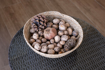 Walnuts in the bowl and dried fruits in the basket