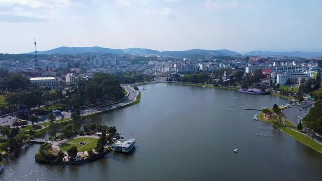 Aerial view of Da Lat City, Lam Dong Province. Drone flies straight towards Xuan Huong Lake.