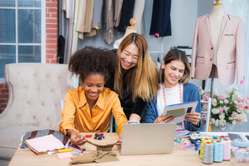 Fototapeta premium Three fashion desingers working or studing , teaching together with smile of happiness in fashion studio room