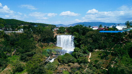 Aerial view of Thac Voi - Elephant waterfall, forest and city scene near Dalat city and Linh An pagoda in Vietnam. Nature and travel concept.