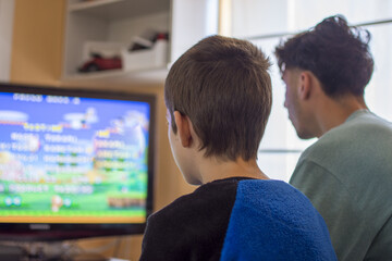 Young Boy Playing Arcade Video Game on a Console at Home 