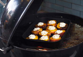 Grill with tasty cut peaches and flame