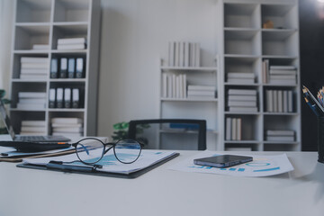 Financial analysts analyze business financial reports on a digital tablet planning investment project during a discussion at a meeting of corporate showing the results of their successful teamwork.