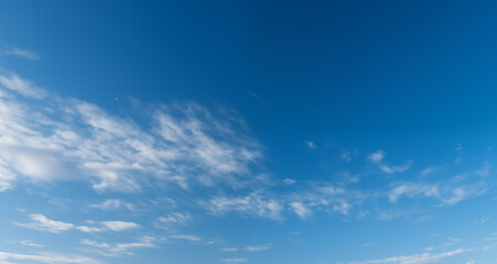 Naklejka na ściany i meble blue sky background with white clouds on a sunny day