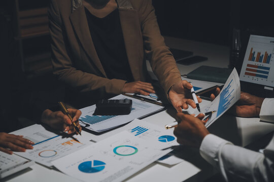 Financial Analysts Analyze Business Financial Reports On A Digital Tablet Planning Investment Project During A Discussion At A Meeting Of Corporate Showing The Results Of Their Successful Teamwork.