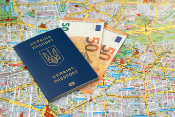 biometric passport of Ukraine of blue color with a trident on the Berlin city map background