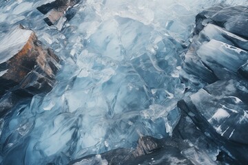 Water in the lake frozen in fancy shapes on the rocks. Close up view of ice. Textured natural background