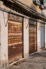 Abandoned shops with rusty roller blinds