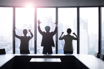 Business people cheering by windows - obrazy, fototapety, plakaty