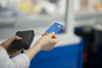 Woman paying with credit card in supermarket